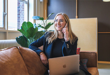 A businesswoman on the phone with a client. UpPayment's team of payment processing consultants knows the right way to grow your business -- a consultative approach.