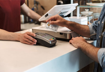 UpPayment deals with man y merchant processor solutions, including the traditional point of use credit card transaction system. Someone is using a credit card to pay a small business.