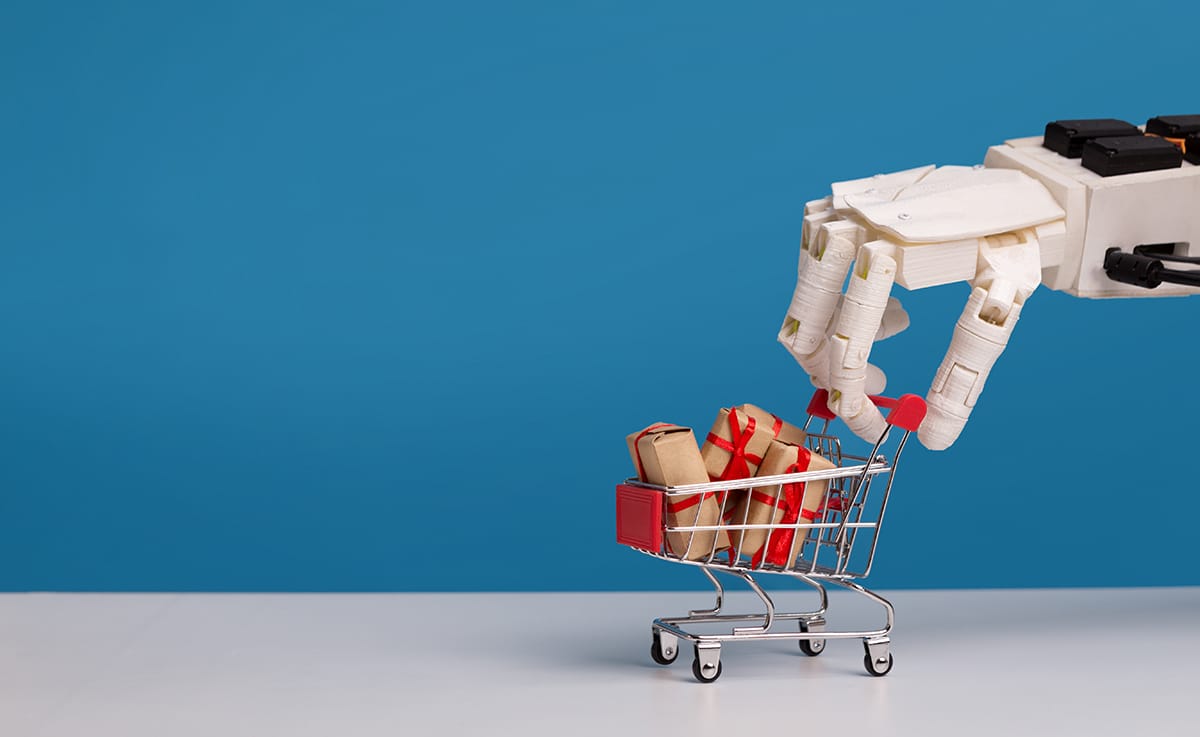 What will the future of ecommerce look like? A robotic hand pushes a small cart full of presents.